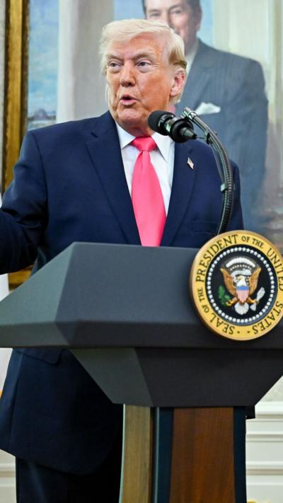 Trump speaking at a podium