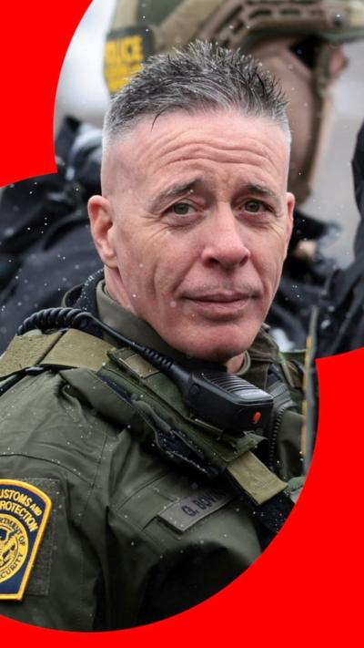 A man, border patrol commander Greg Bovino, in uniform looking at the camera.