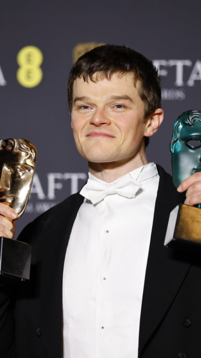 Actor Robert Aramayo holding two Bafta awards