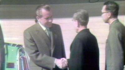 US President Richard Nixon shakes hands.