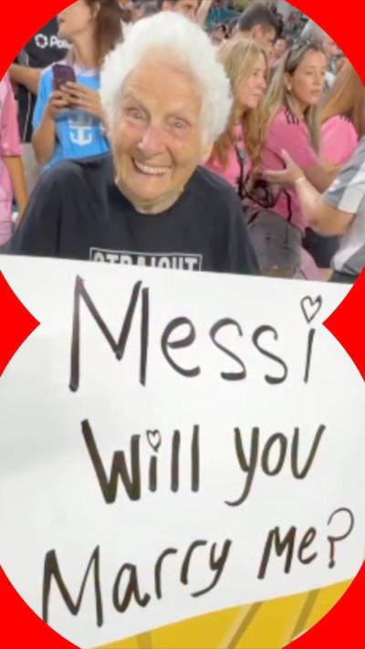 Paula holding a sign that reads 'Messi will you marry me?'