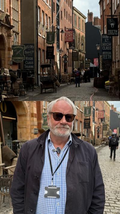 A composite photo of two images. At the top is an old looking street with carts and large signs hanging off the buildings. Below is a man with white hair and stubble in black sunglasses, a black jacket, blue shirt and lanyard.