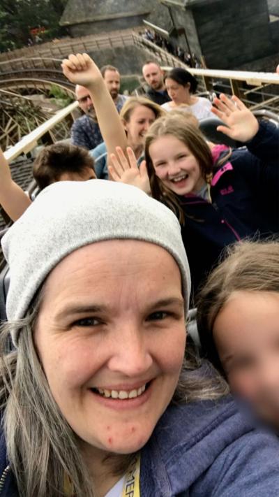 A family ride a roller coaster at a theme park