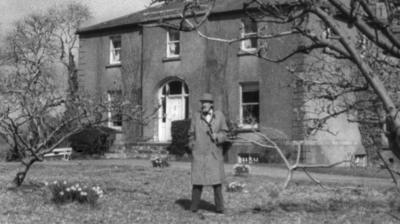 Fyfe Robertson stands outside the home of Captain Boycott.