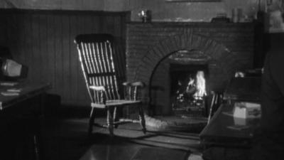 The haunted chair next to a fireplace