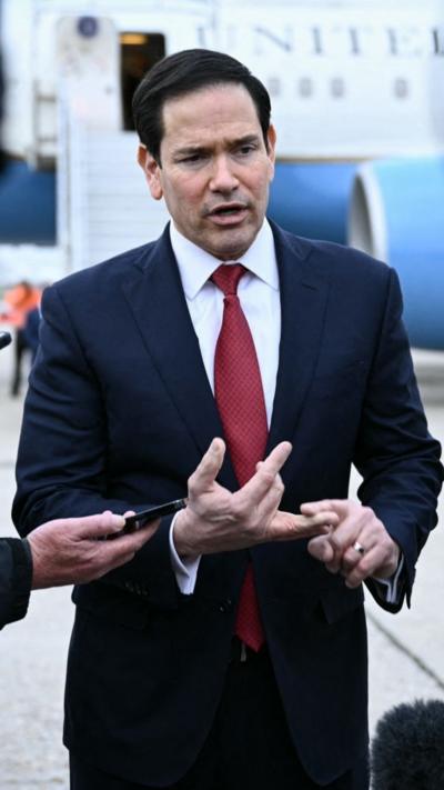 Marco Rubio stands in front of Air Force one