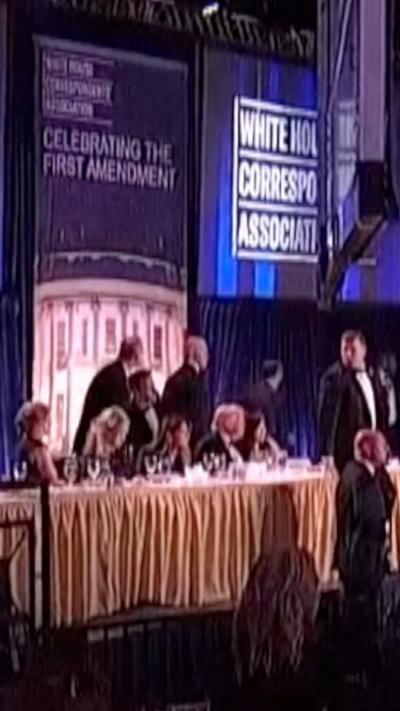 Trump sitting at head table before being escorted out