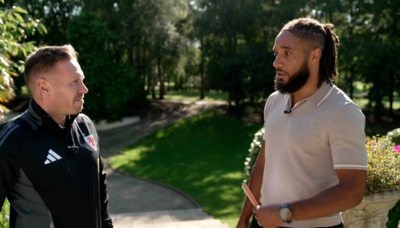 Wales head coach Craig Bellamy talks to former team-mate Ashley WIlliams