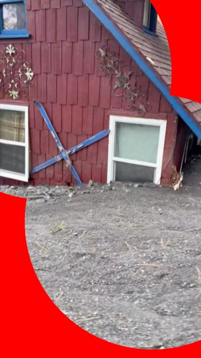 House partially submerged in mud