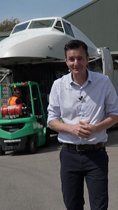 A man standing in front of a large aircraft