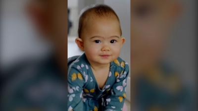 A baby crawls on the ground