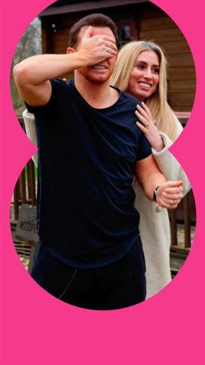 Stacey Solomon with her arms around Joe Swash, who is covering his face