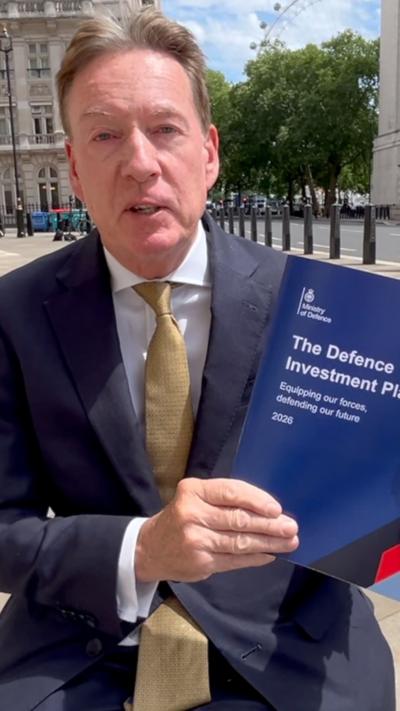 Frank Gardner holding the Defence Investment Plan document outside of Westminster