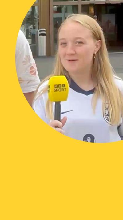 England fan speaking into BBC Sport-branded microphone and looking into camera