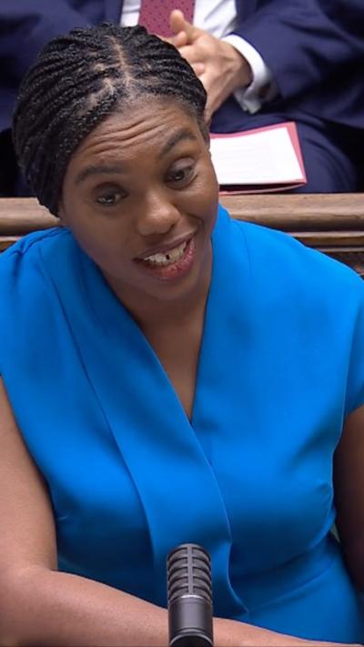 Leader of the opposition Kemi Badenoch wearing blue dress