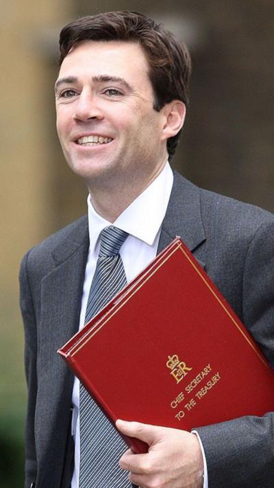 A young Andy Burnham in a grey suit and tie