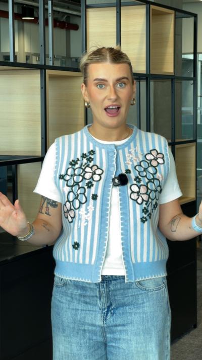 Journalist Eve Beattie - a young woman wearing a blue striped vest, speaking to camera