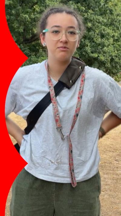 Woman in park dressed in grey shirt and dark green trousers