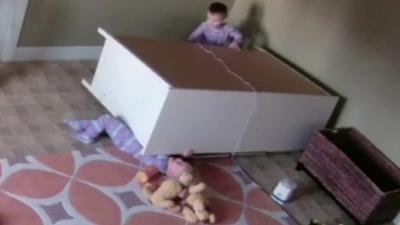 Two-year-old under the drawers