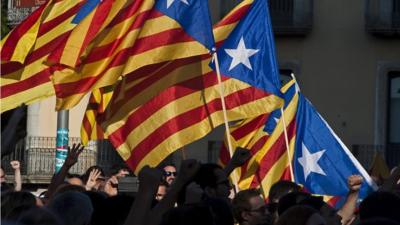 Protesters carry Catalan flags