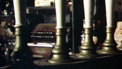 Row of draft beer pumps in an old-fashioned 1940s bar.