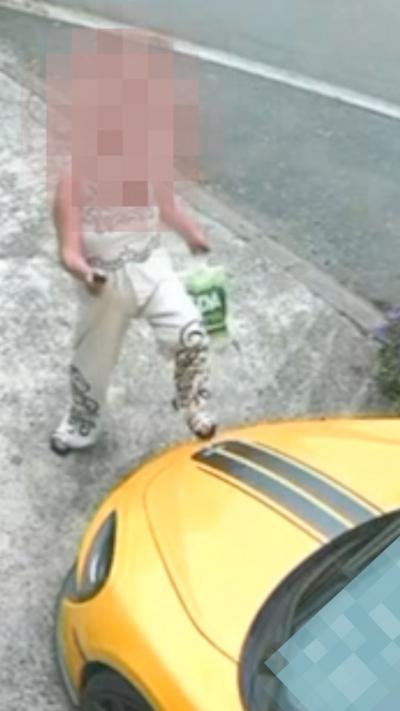 blurred image of woman kicking yellow car