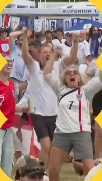 Fans shouting and raising their arms in the air after England score a goal