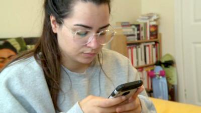 A woman looking at her mobile phone