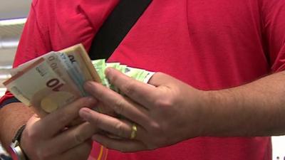 British tourist counting money