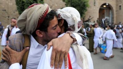 Yemeni detainees hug relatives after being released by the rebel Houthi movement in Sanaa (30 September 2019)