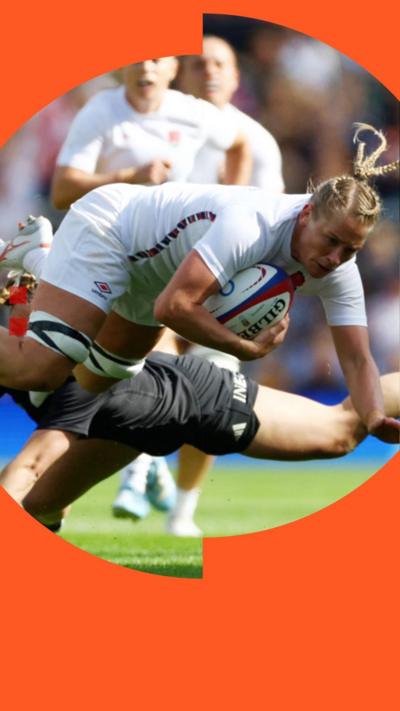 English female rugby player diving for the line while being tackled