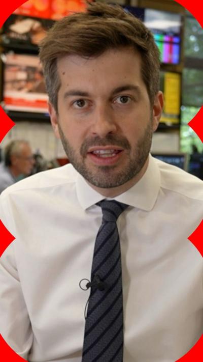 Joe Today looks at the camera. He wears a white shirt and dark blue striped tie.