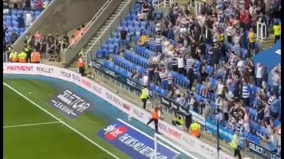 Reading supporters throw tennis balls onto the pitch in protest over the club's ownership.