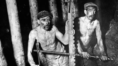 Two miners in a mine
