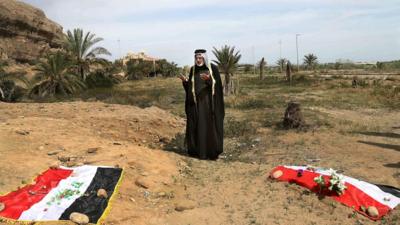 Man prays for his relative at mass graves site in Iraq