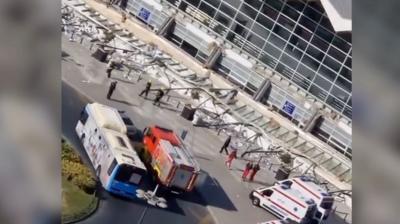 Collapse canopy in front of station with emergency vehicles