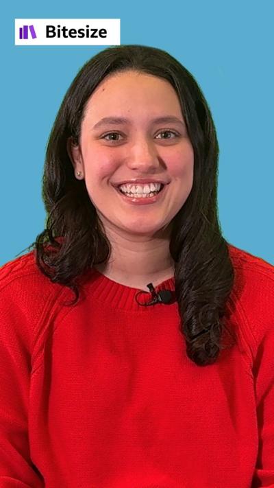 A close up shot of a young woman in front of a blue background