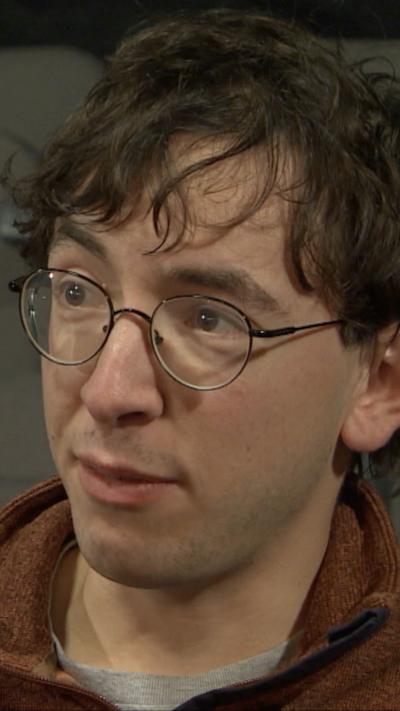 Belfast media student Rory Morrow speaking to BBC News NI.  He has short brown hair and is wearing glasses and a brown fleece over a grey t-shirt.