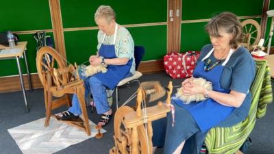 Women using spinning wheels