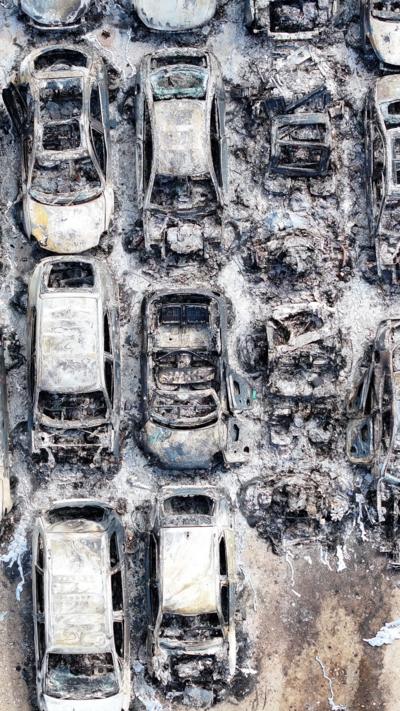 Aerial shot of lots of burnt out cars 