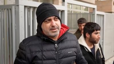 Man in black beanie and black puffer 