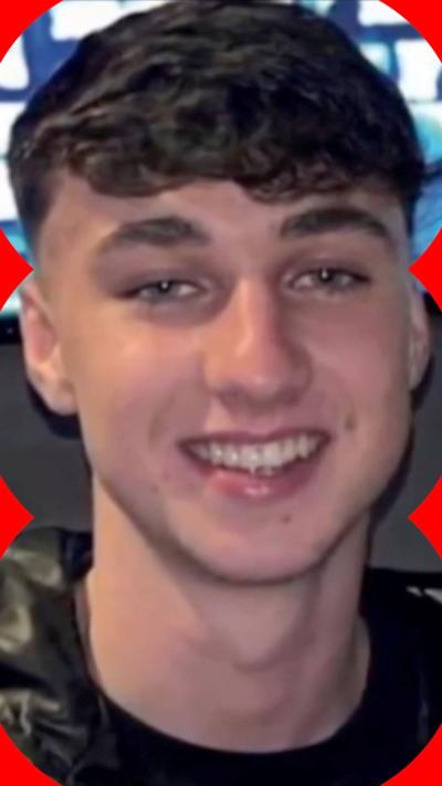Jay Slater smiles at the camera. He has short black hair. 