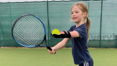 Joanie preparing to serve a ball