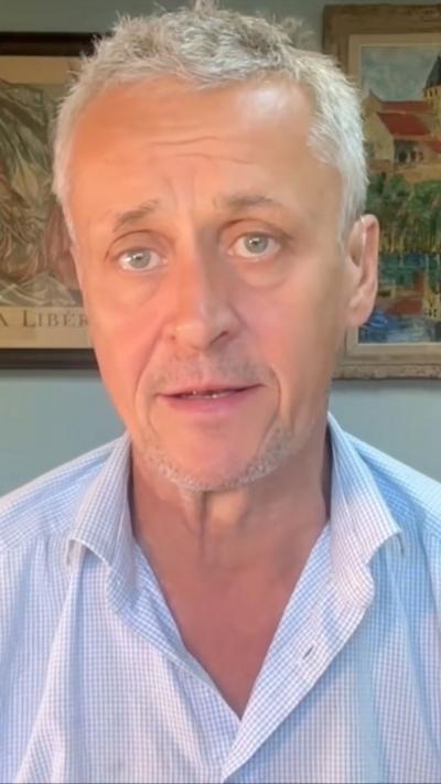 Hugh Schofield sits in his front room in France