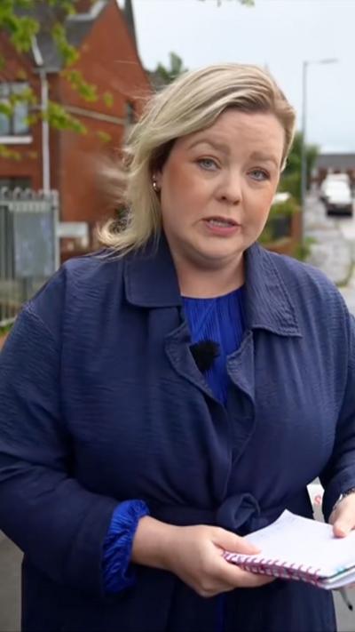 BBC correspondent Sara Givin wearing blue jumper and navy trench coat