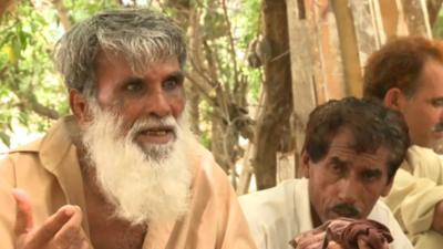 Labourers wait for work in the heat