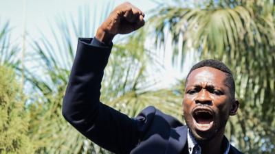 Bobi Wine with his right fist raised in the air