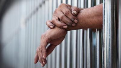 Prisoner behind bars