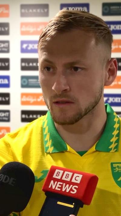 Norwich City player Harry Darling wearing club's yellow and green shirt