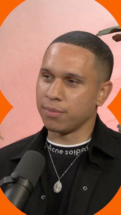 A screengrab of Jordan Schwarzenberger on the Radical podcast, where he is sat down and a black microphone is visible in the bottom of the shot.
